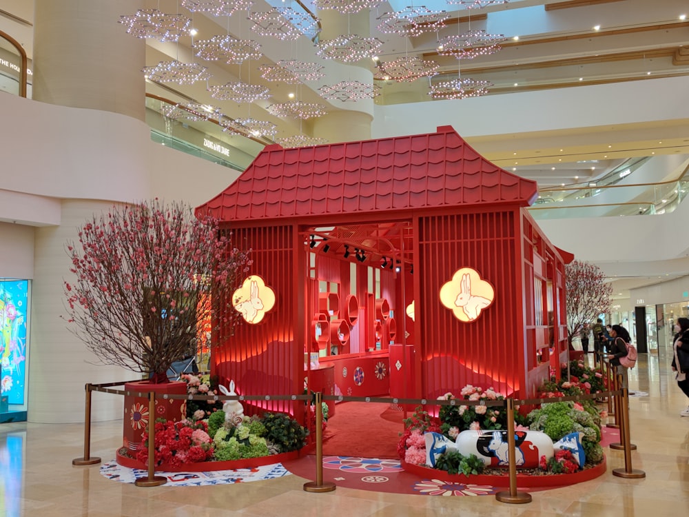 a red building with a red roof in a mall