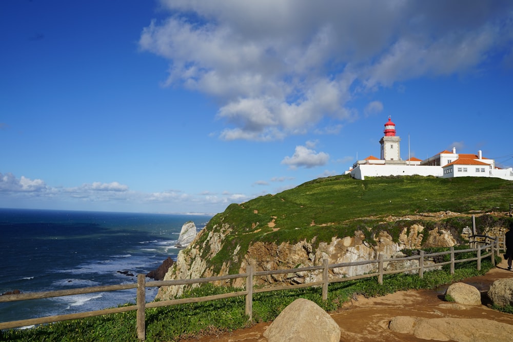 a lighthouse on a cliff overlooking the ocean