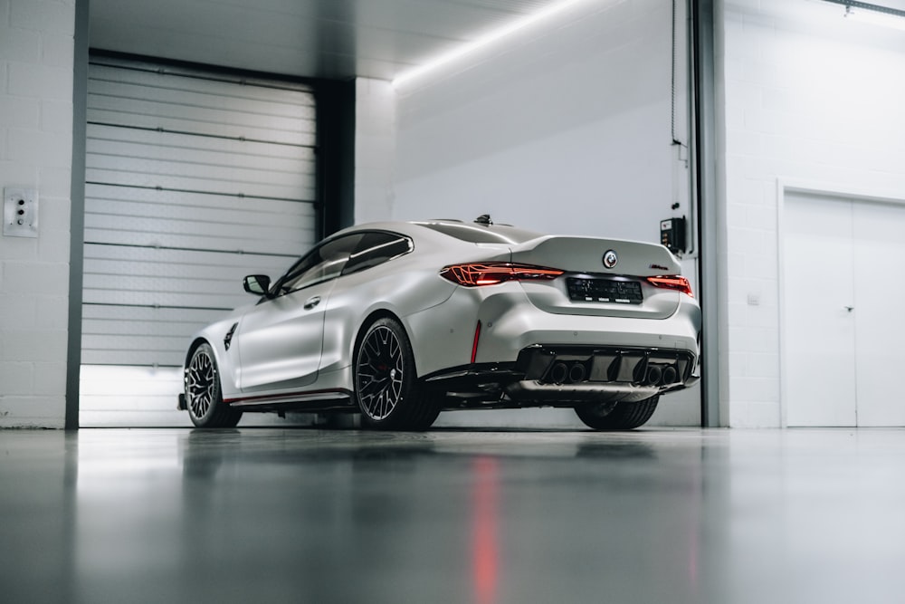 a white sports car parked in a garage