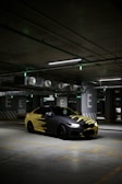 a yellow and black car parked in a parking garage