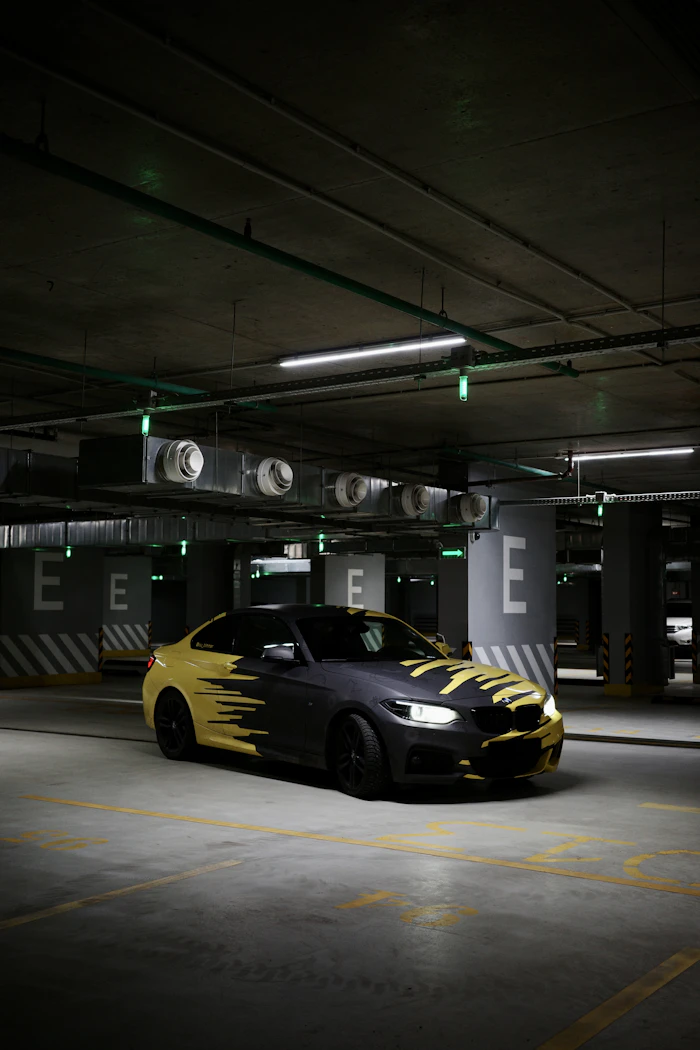 Black and yellow car in parking garage