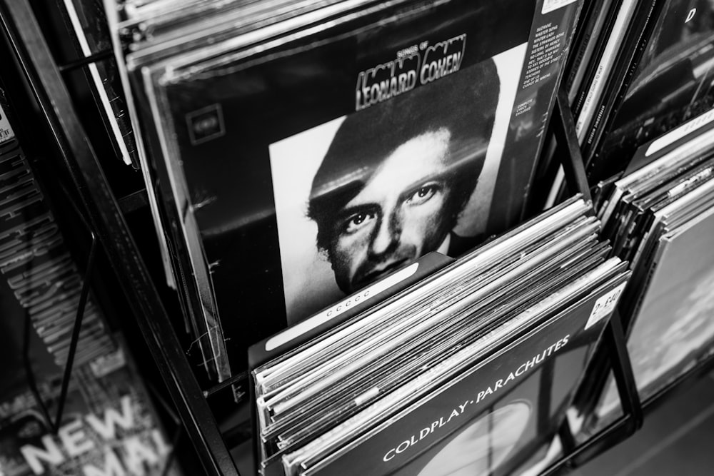 a stack of records sitting on top of a shelf