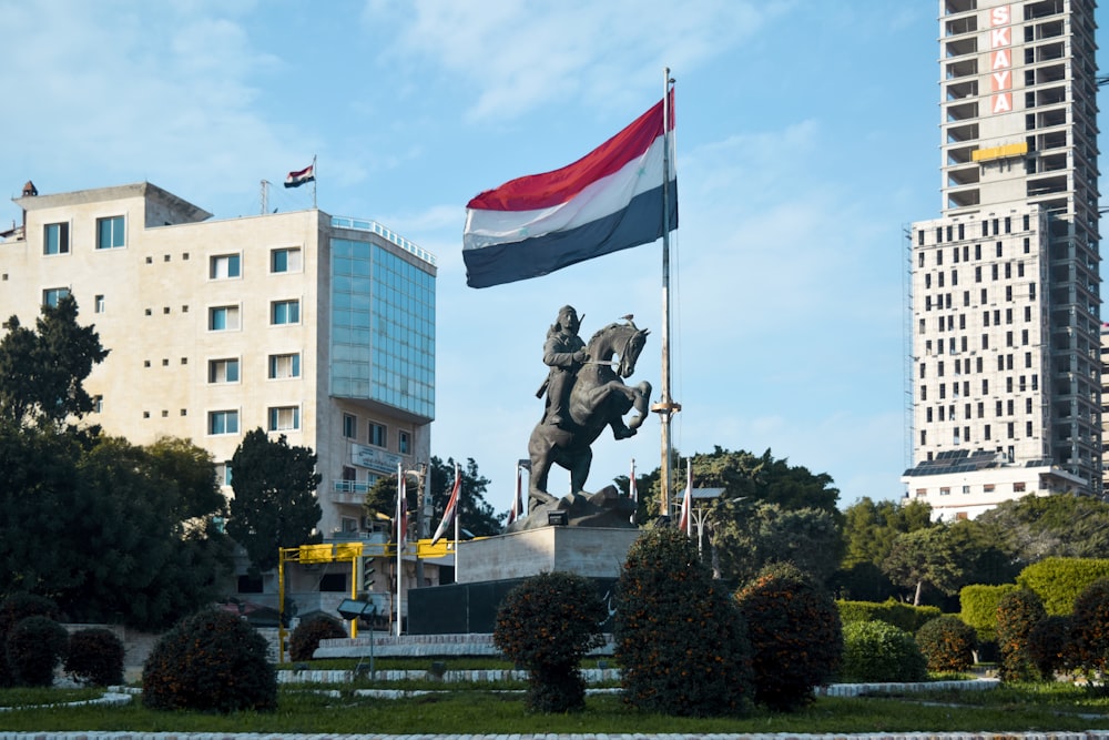 a statue of a man riding a horse holding a flag