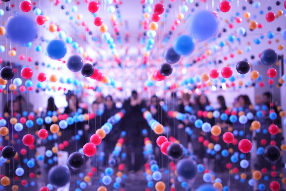 a room filled with lots of balloons floating in the air