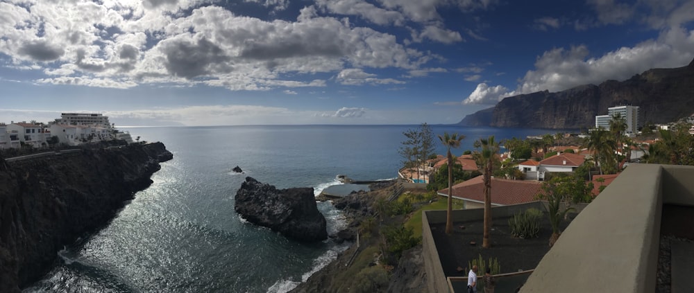 a person standing on a balcony overlooking the ocean