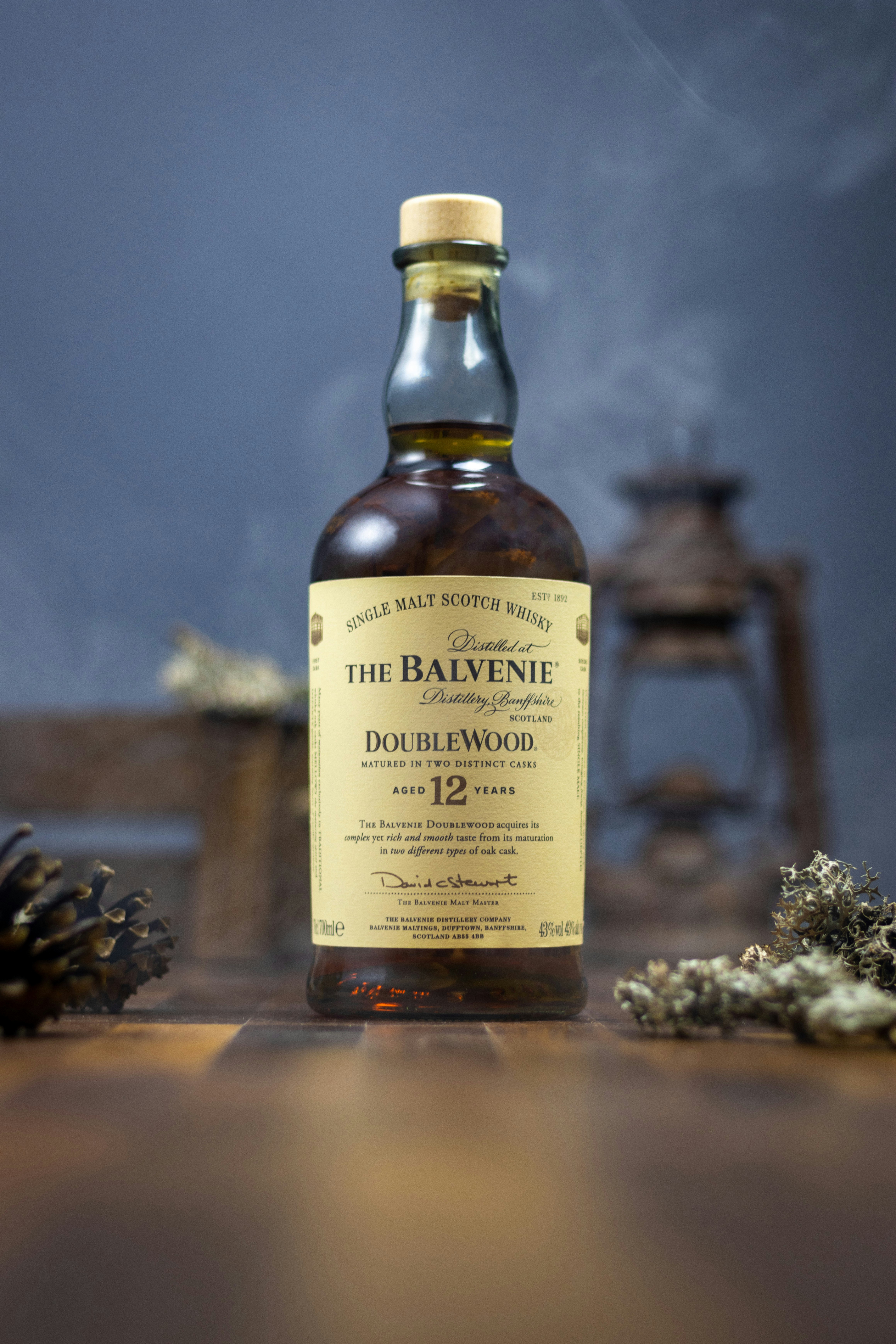 a bottle of whiskey sitting on top of a wooden table