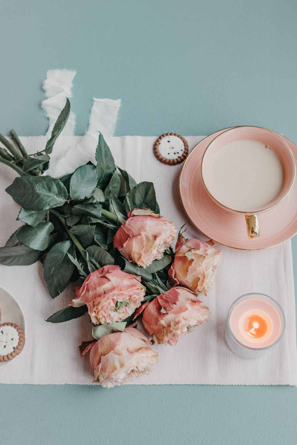 a table topped with a plate of food and a cup of coffee