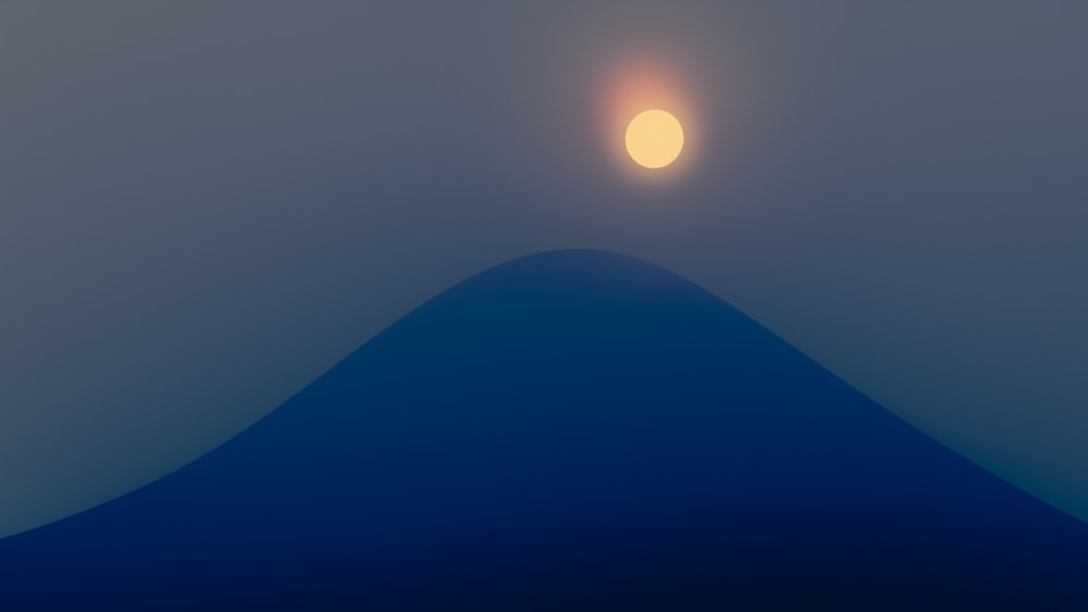 the sun is setting over a mountain in the fog