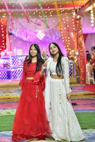 A group of women wearing stylish ethnic outfits at a festive event.