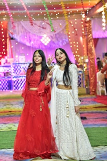 A group of women wearing stylish ethnic outfits at a festive event.