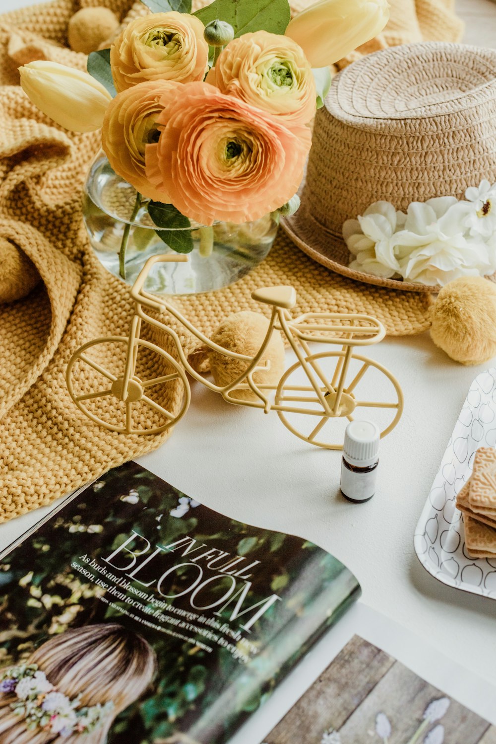 a table topped with a book and a vase filled with flowers