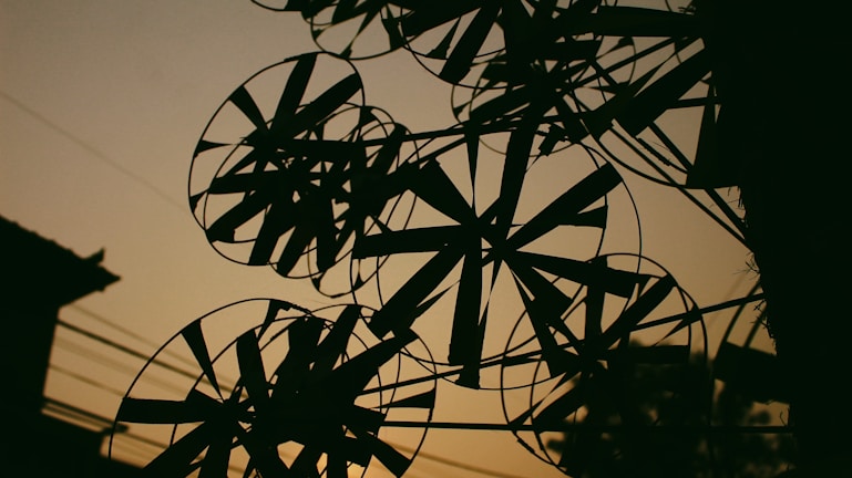 Futuristic digital grid pattern merging with a windmill silhouette at dusk.