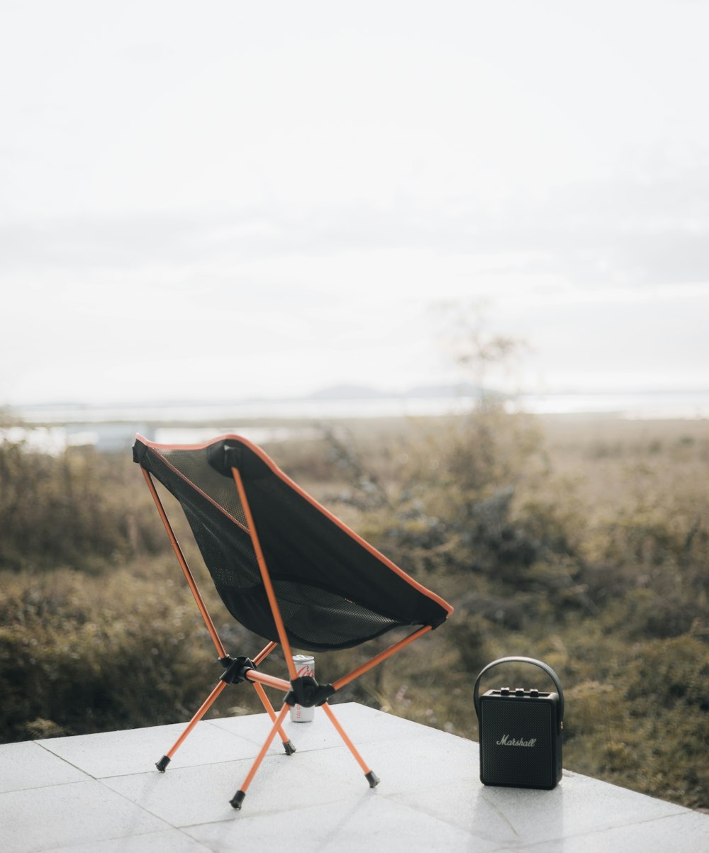 a chair sitting on top of a table next to a radio