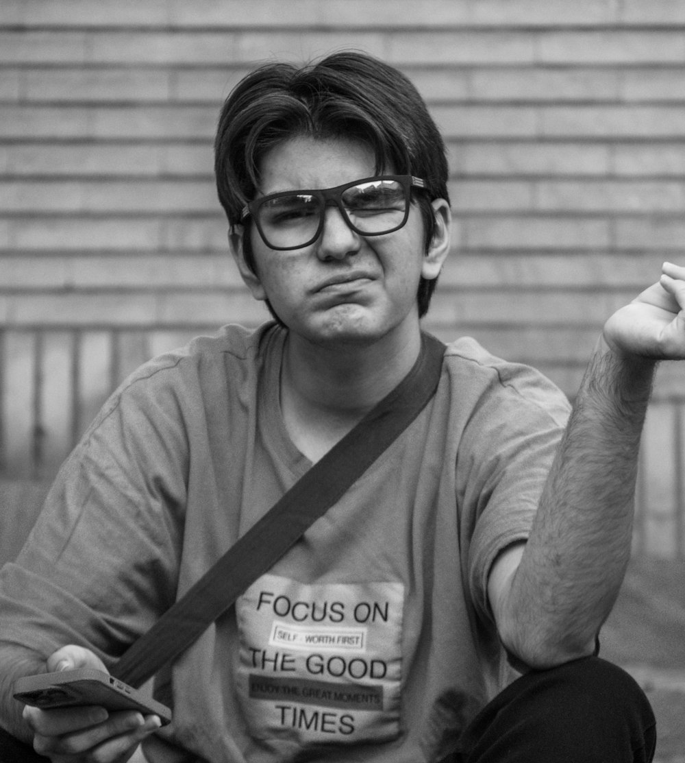 a man sitting on the ground smoking a cigarette