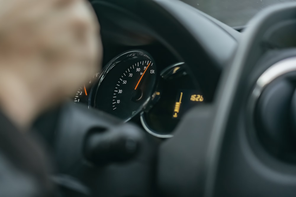 a close up of a car dashboard with a speedometer