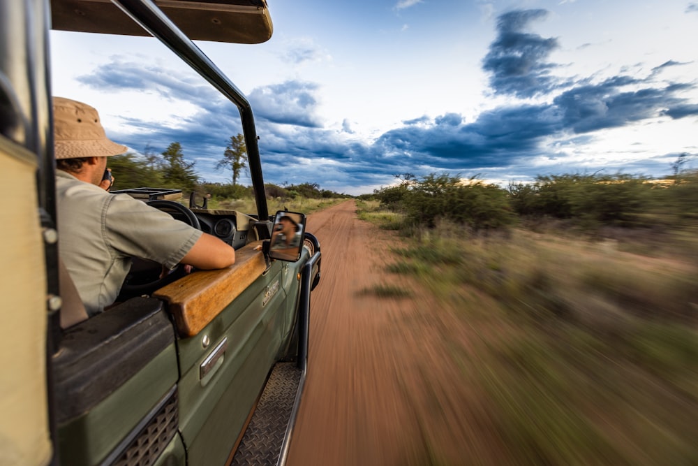 a man driving a truck down a dirt road