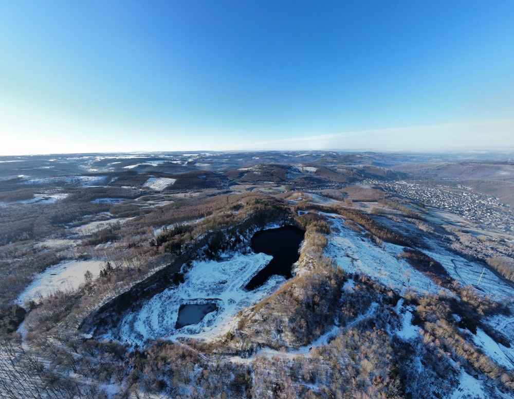 an aerial view of a snow covered landscape