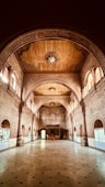 a large hall with a clock on the ceiling