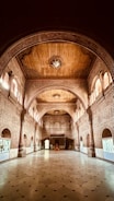 a large hall with a clock on the ceiling