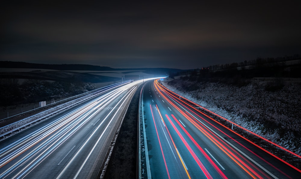 a long exposure photo of a highway at night