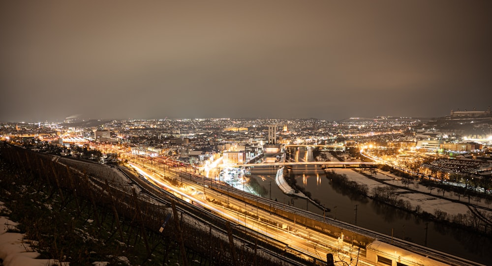 a view of a city at night from a hill