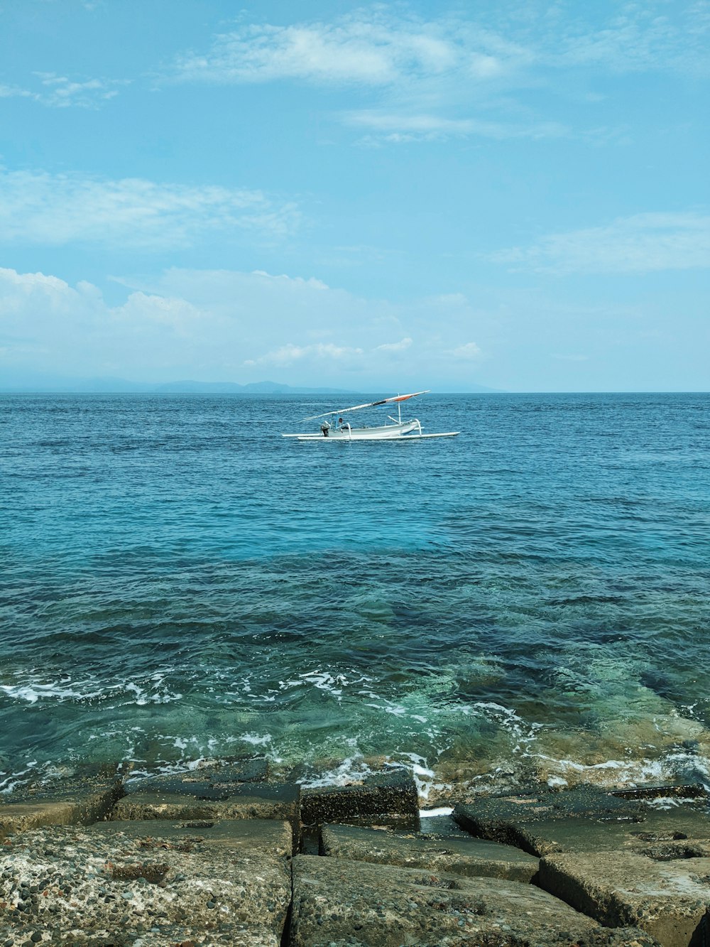 a boat is out in the ocean on a sunny day