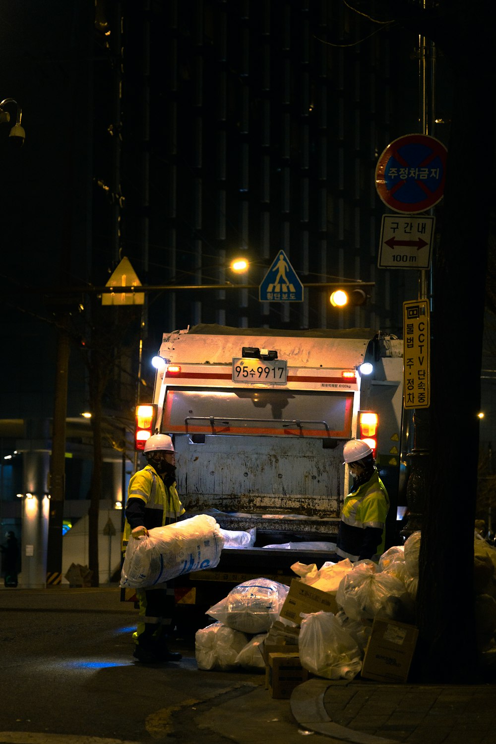 a garbage truck parked on the side of the road