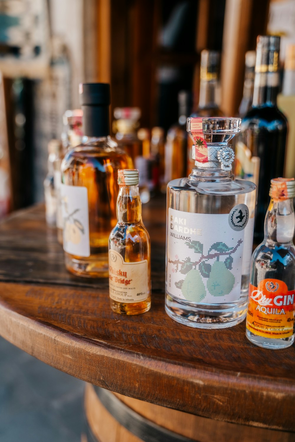 a wooden table topped with bottles of alcohol