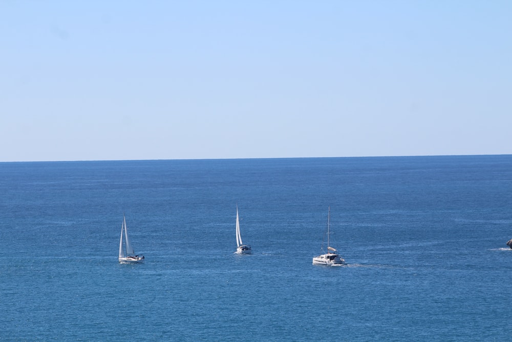 a group of boats floating on top of a large body of water