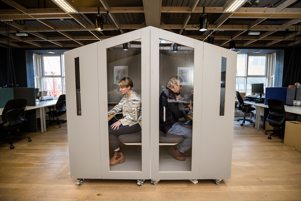 a couple of people sitting inside of a room