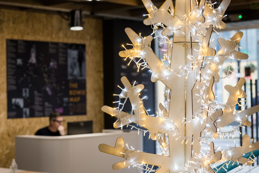 a white christmas tree with white lights on it