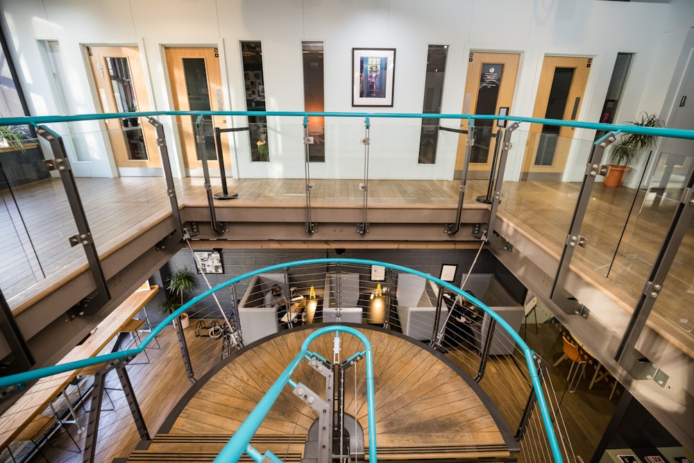 a spiral staircase in a large building with glass railings