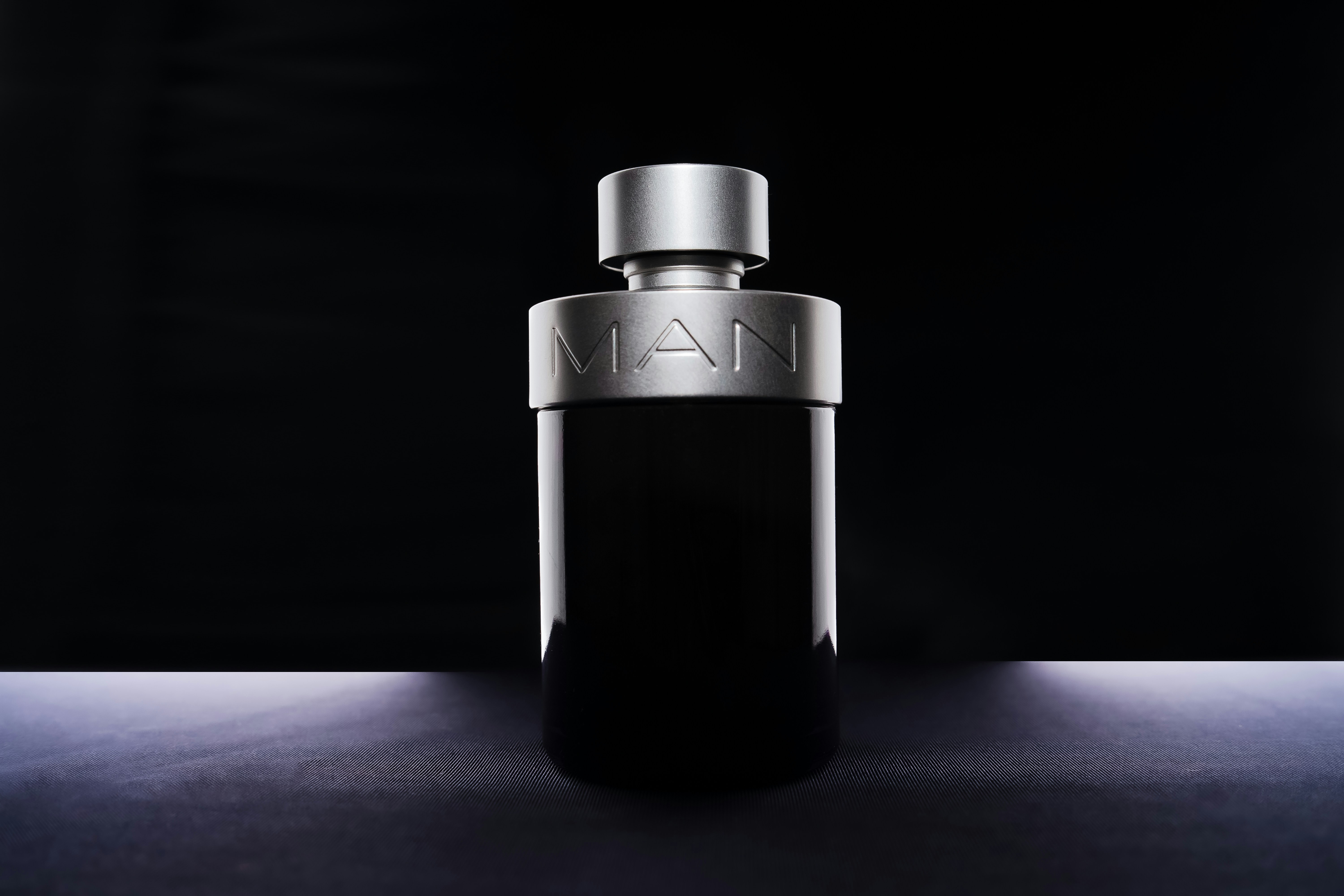 a bottle of man cologne sitting on a table