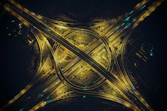 Night view of a lit-up highway interchange showcasing complex engineering and smooth traffic flow.