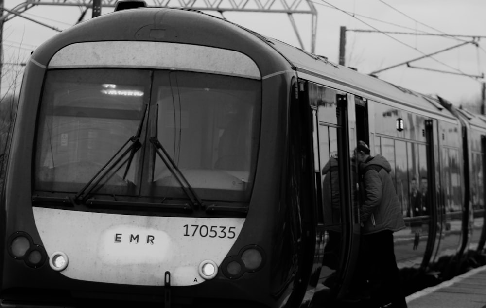 a black and white photo of a train at a station