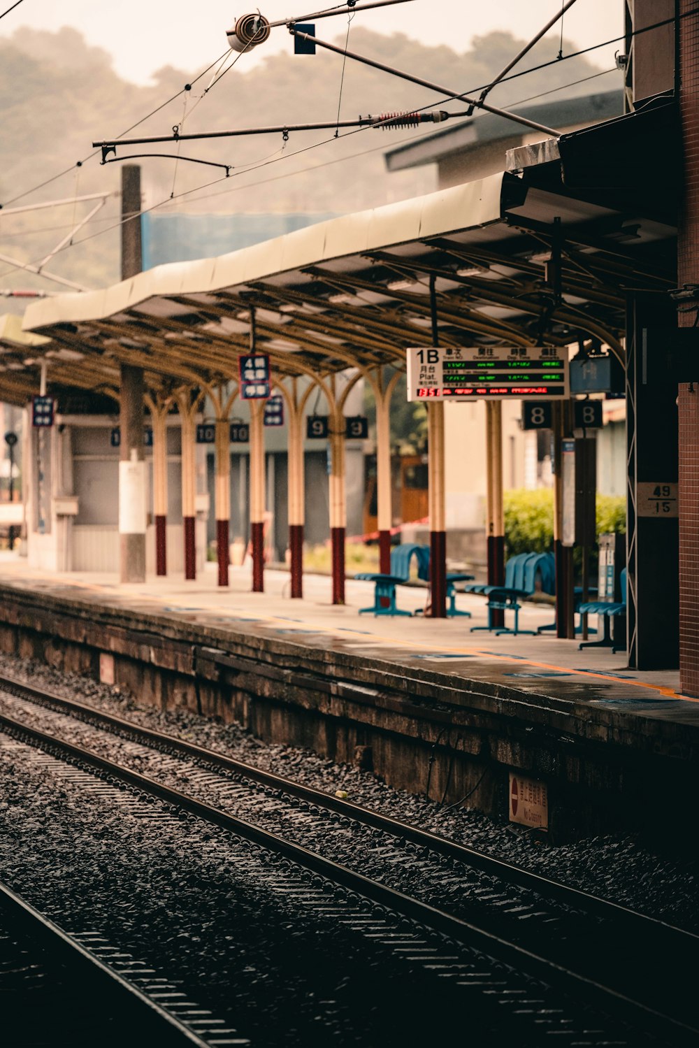 a train station with a train on the tracks