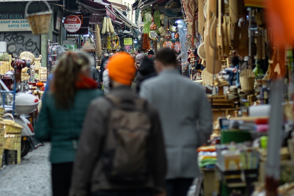 a group of people walking through a market