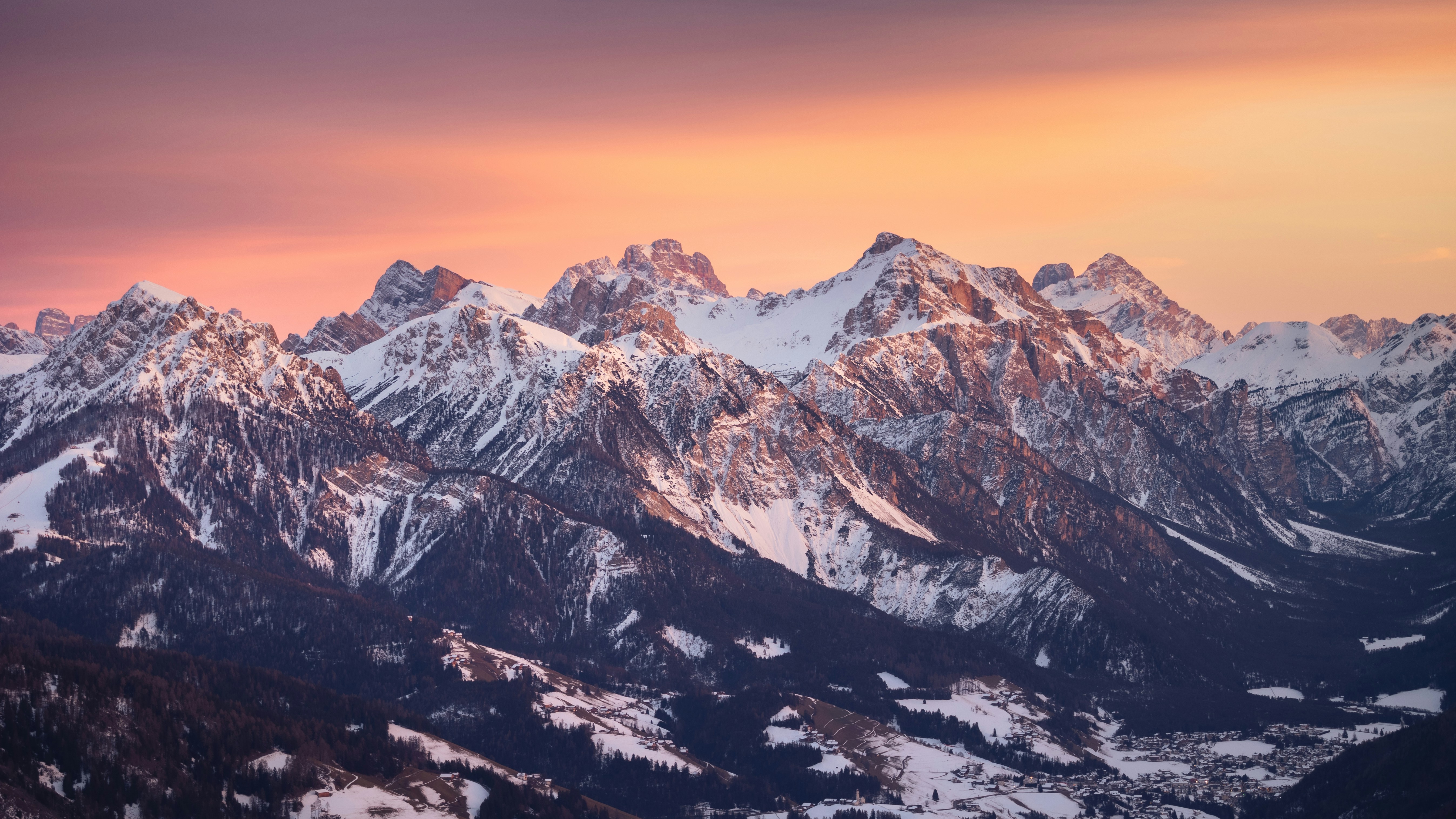 A mountain range with snow covered mountains in the background