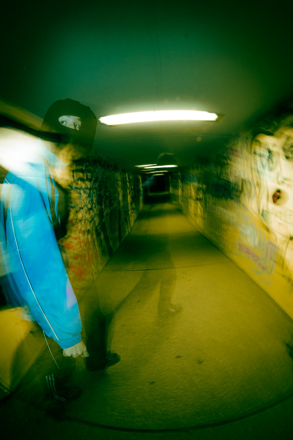 a blurry photo of a person walking down a tunnel