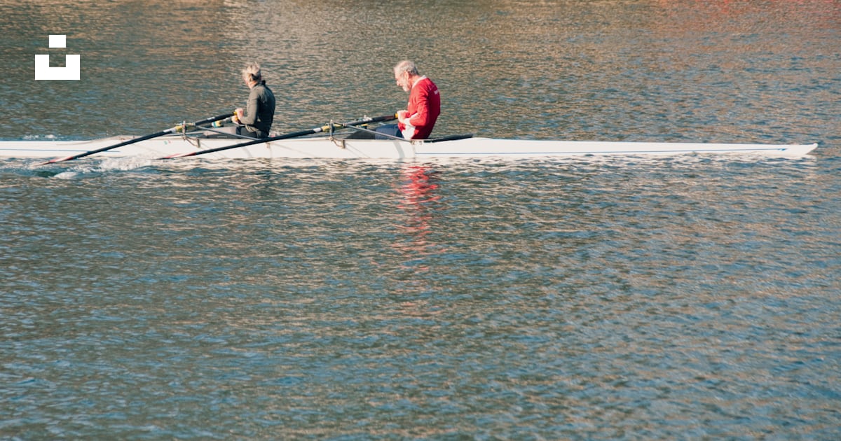 Two men rowing a boat on a body of water photo – Free Turin Image on ...