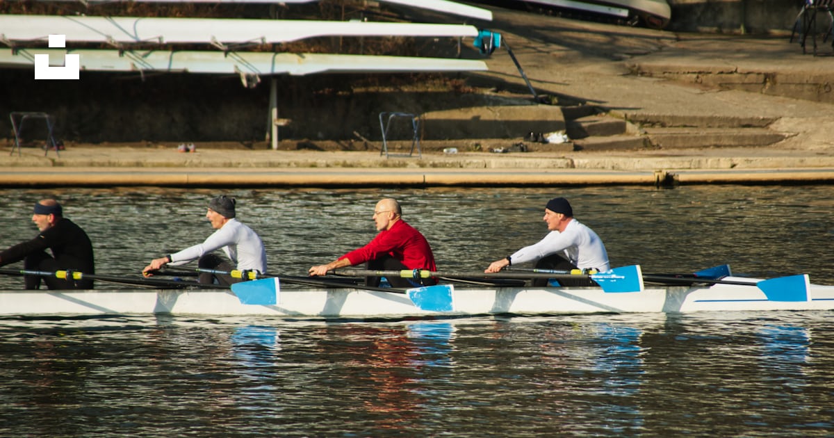 A group of people rowing a boat on a body of water photo – Free Turin ...