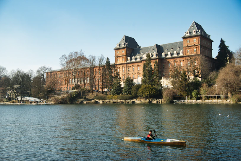 a person in a kayak in front of a large building