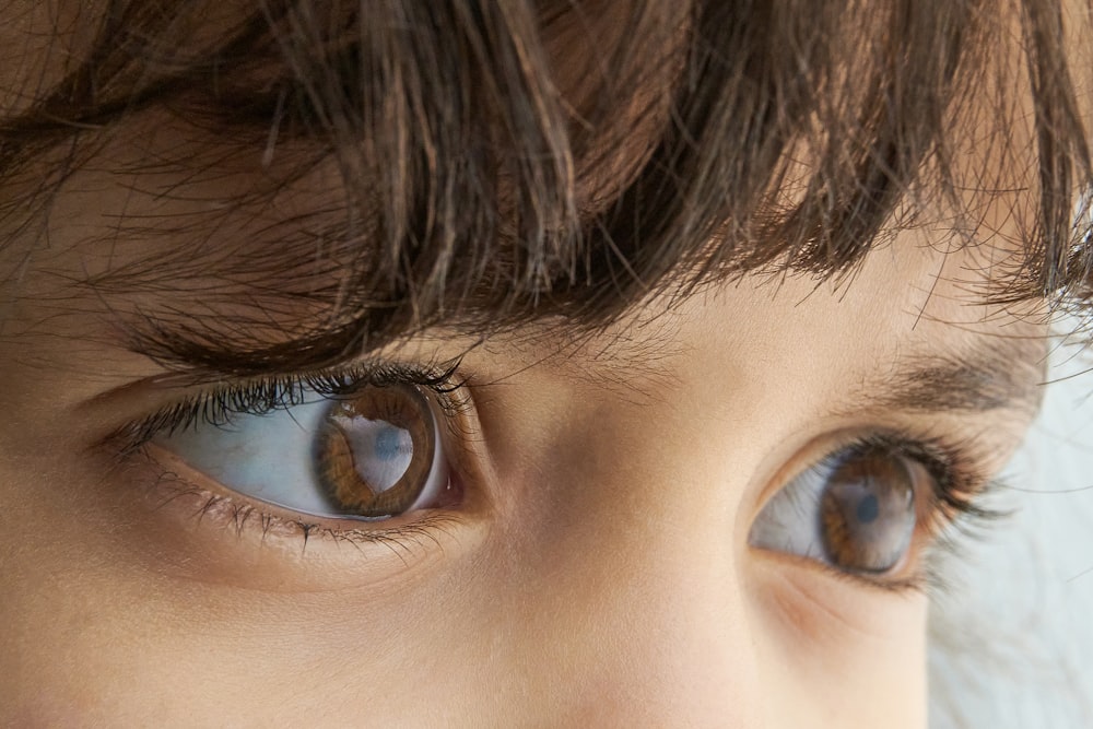 a close up of a child's blue eyes