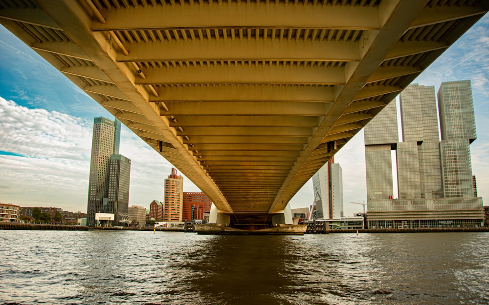 the underside of a bridge over a body of water