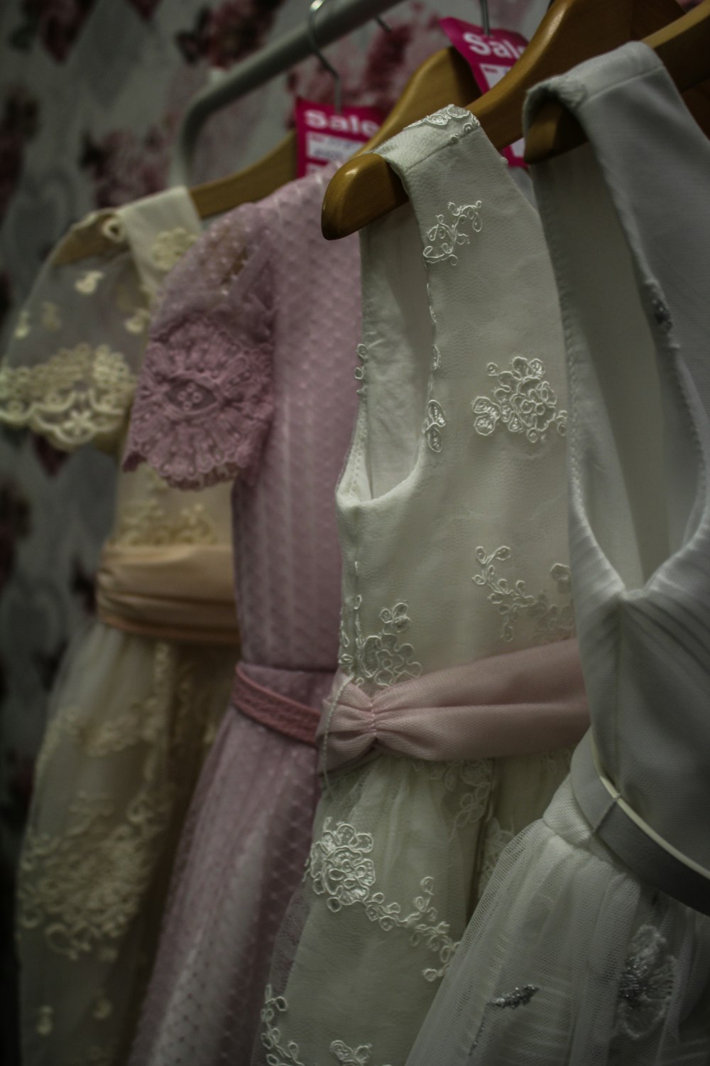 a row of dresses hanging on a rack