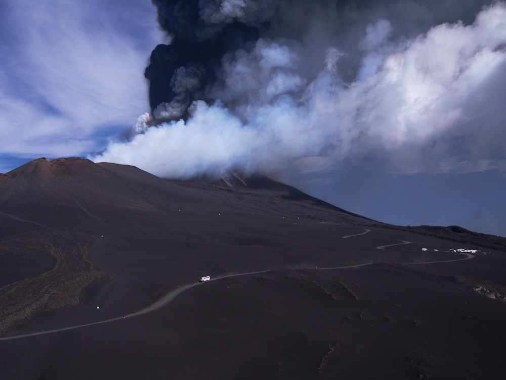 a large plume of smoke rising from a volcano