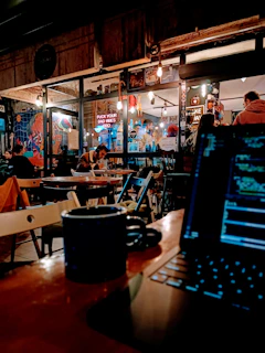 A cozy coffee shop corner filled with people working on laptops and chatting