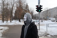 a person wearing a mask standing in the snow