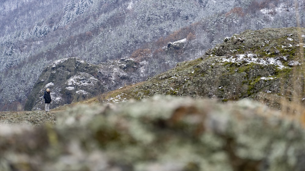 a person standing on top of a rocky hill