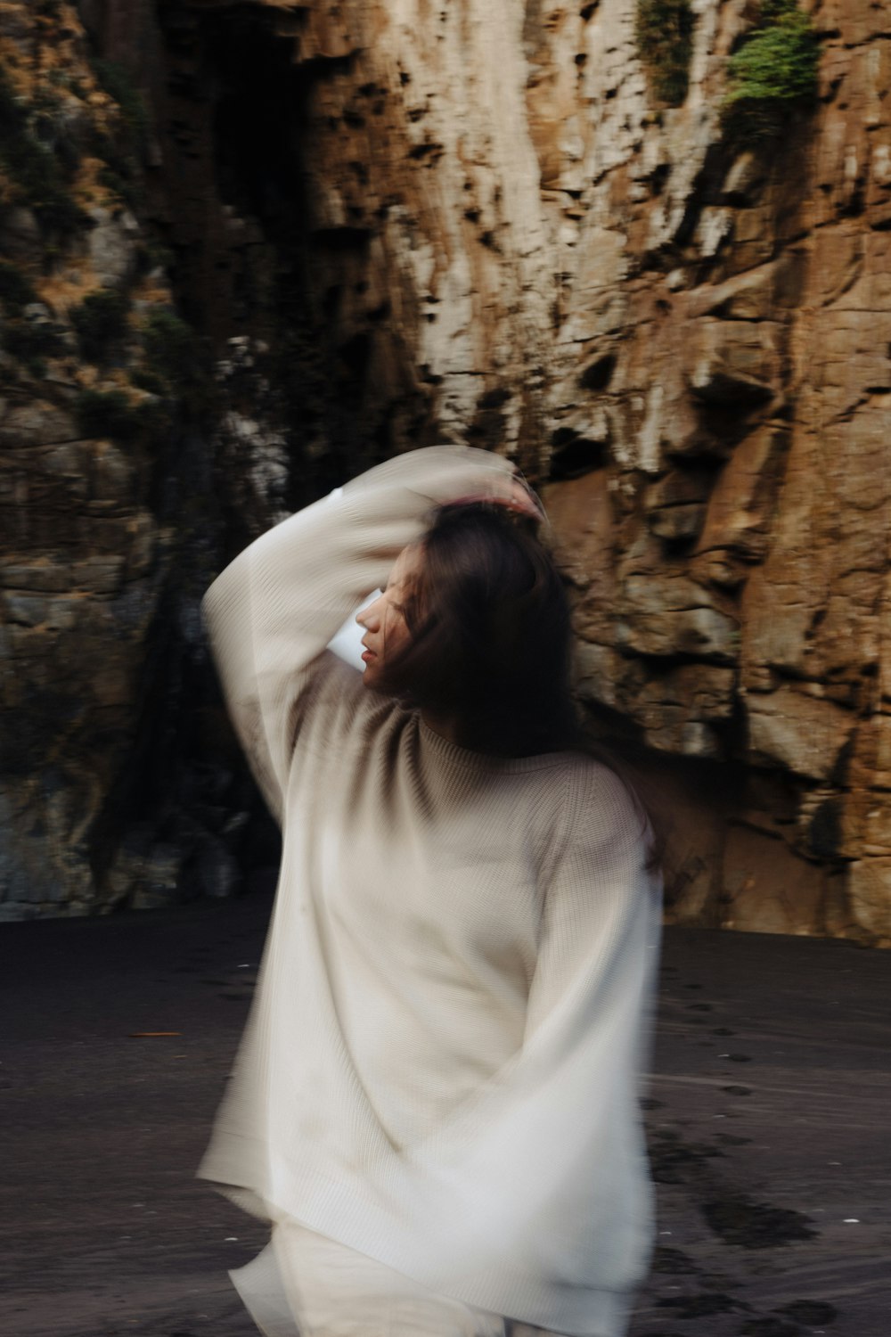 a woman in a white dress walking down a street